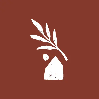 Logo de Nomad Eleven, fond terracotta et visuel d’une maison avec une feuille.
